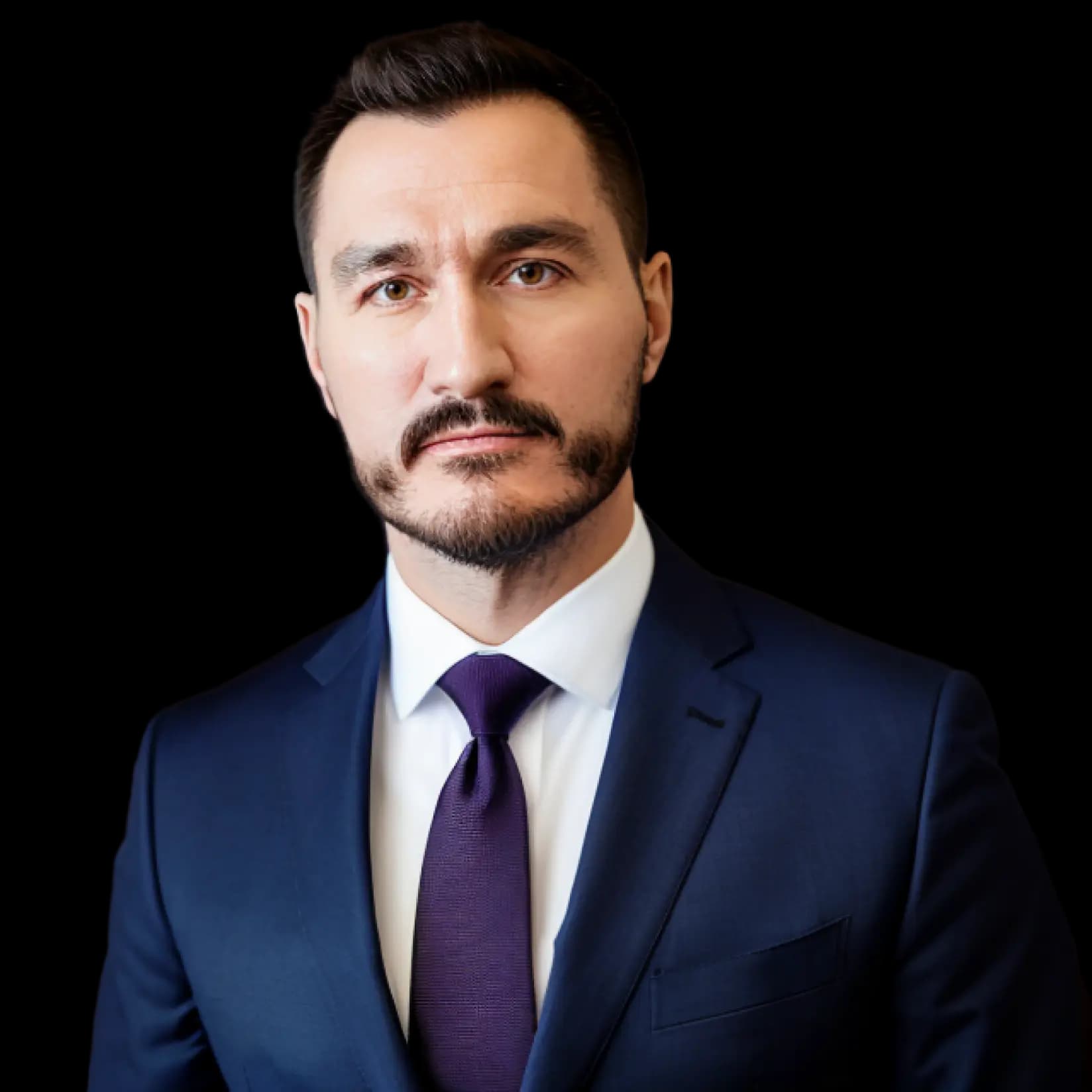 Professional headshot of Kyle Vance, web developer, wearing a dark navy suit and purple tie, with a neutral expression, against a plain background.